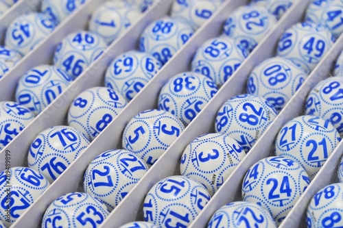 Boxed bingo balls arranged in rows close up view narrow focus field