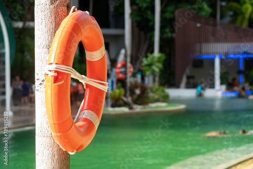 A lifebuoy hangs on the side of the swimming pool.