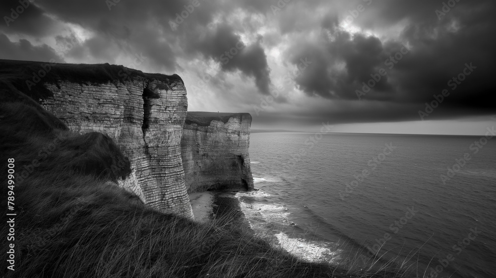 Black and white photography of the cliffs and seascape, dark with clouds. Landscapes photography - obrazy, fototapety, plakaty 
