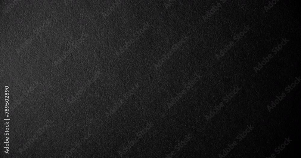 Black rough paper surface, slow moving. Use for background and texture. Black rough paper surface, slow moving. Use for background and texture.
