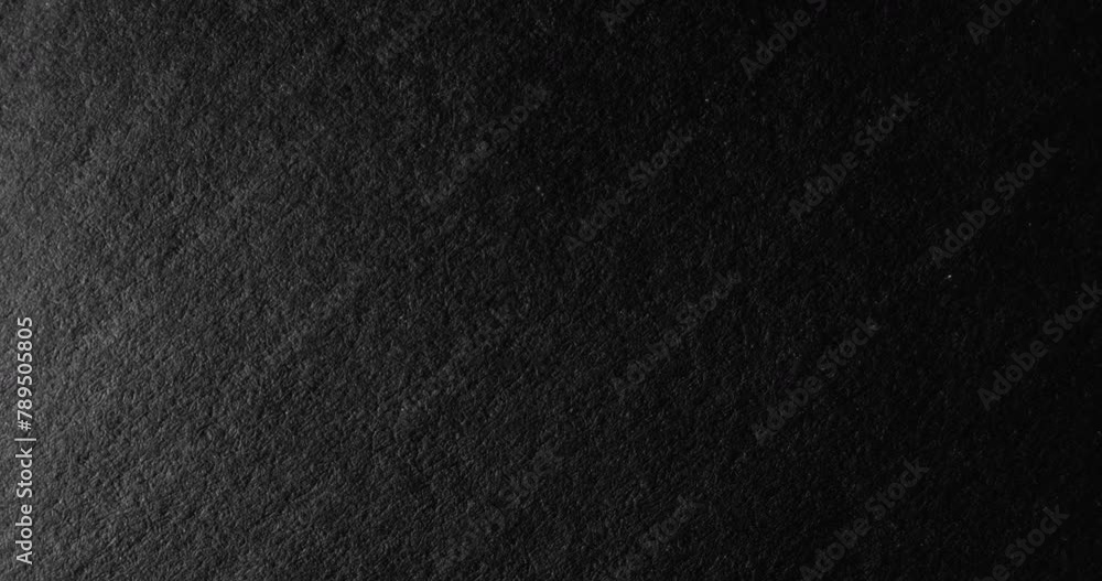 Black rough paper surface, slow moving. Use for background and texture. Black rough paper surface, slow moving. Use for background and texture.