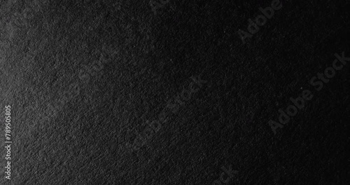 Black rough paper surface, slow moving. Use for background and texture. photo