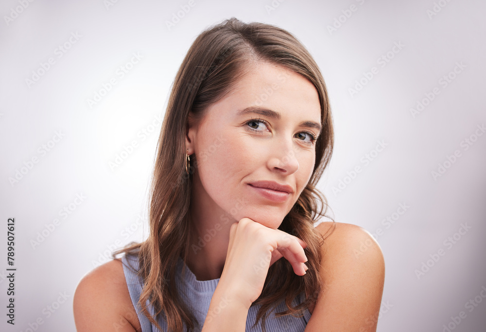 Naklejka premium Beauty, natural and portrait with relaxed woman on studio gray background for inspiration or wonder. Casual, face and wellness with confident person looking calm for contemplation, idea or thinking