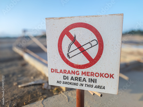 warning board with the words dilarang merokok di area ini in English no smoking in this area © Muhammad