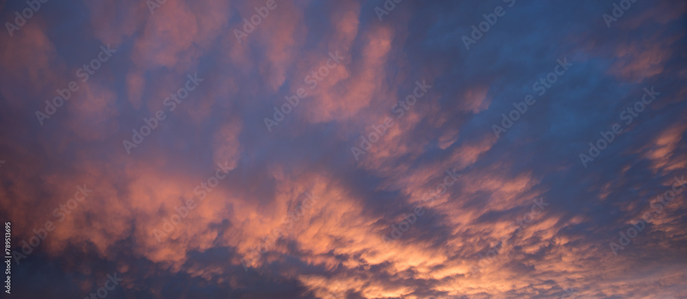 colorful sunset sky with mammatus clouds, orange and purple colored