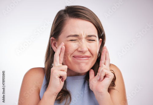 Photos Woman, fingers crossed for wish or hope with praying, superstition or faith for success on white background