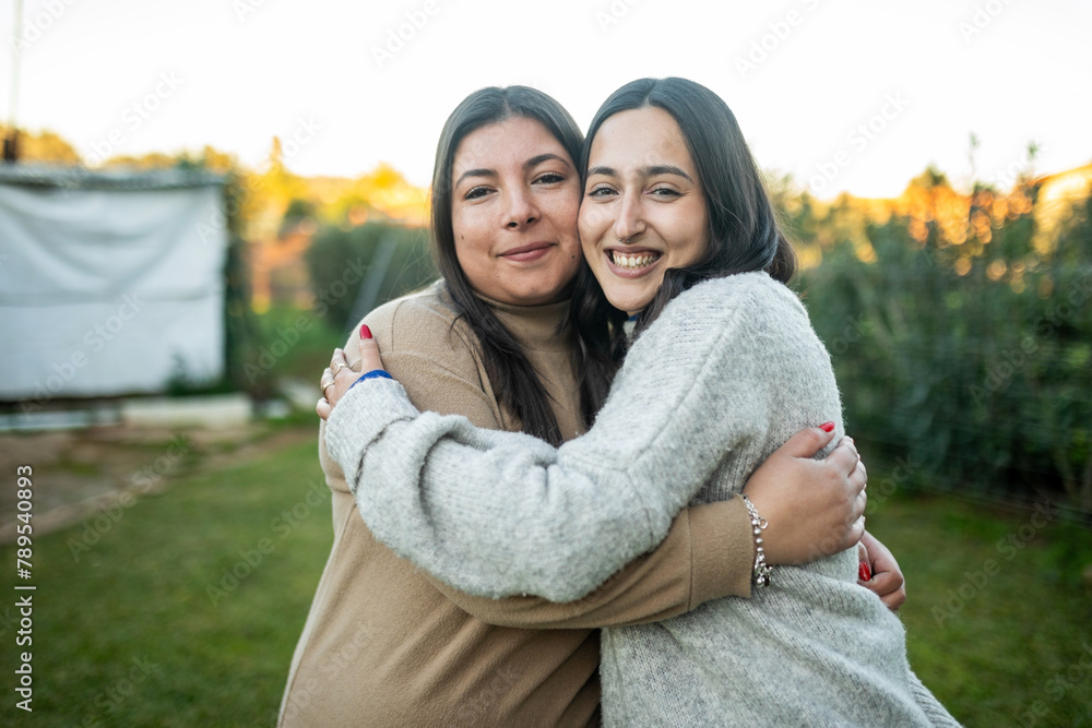 portrait of women hugging outdoors portrait of women hugging outdoors