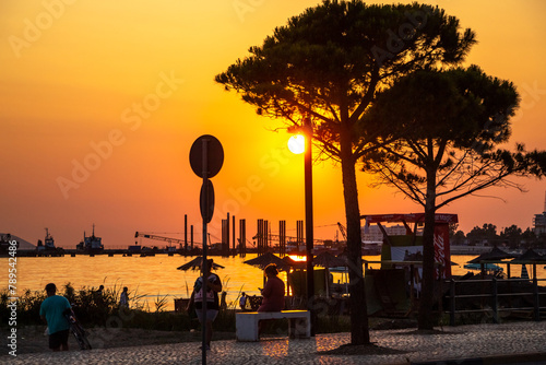 Seaside promenade with a view of the sea at sunset photo