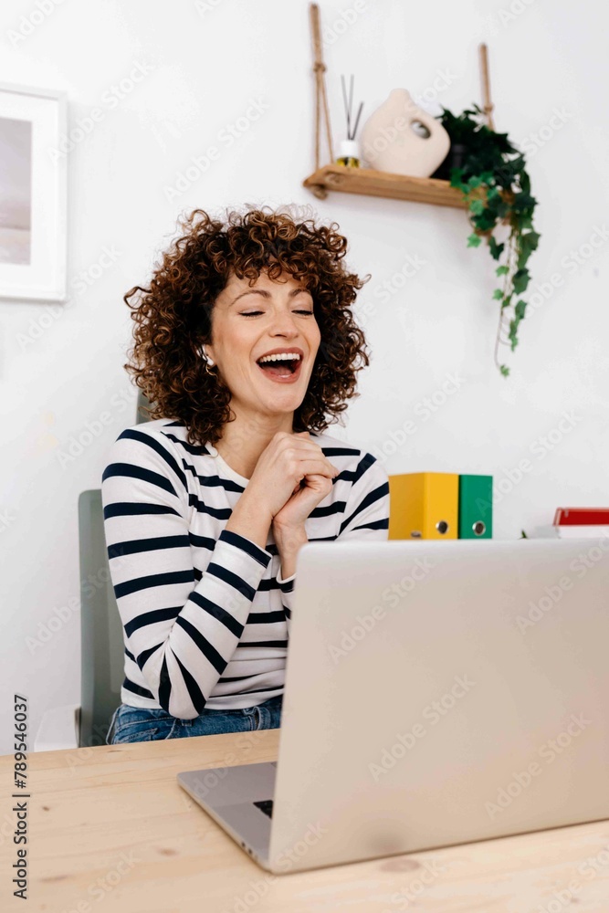 Cheerful woman with laptop in office Cheerful woman with laptop in office