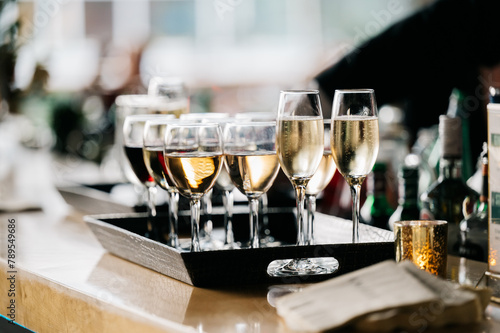 Glasses of wine and sparking wine on a tray photo