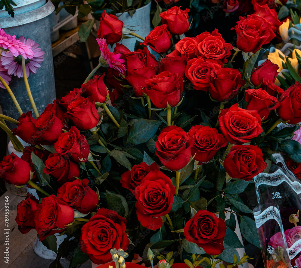 Selling bouquet of red roses at a market in Turin