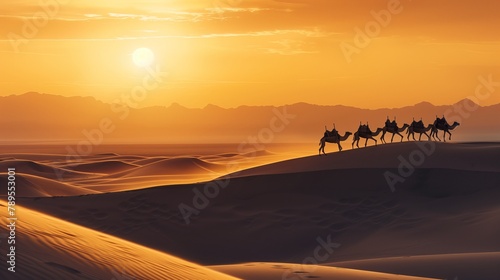 Lovely desert sunset with camel silhouettes on the sand dunes