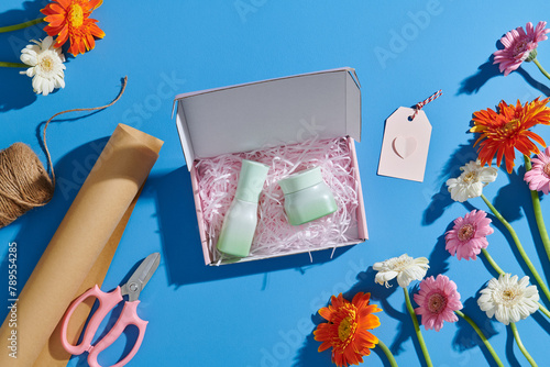 Love gift love theme. Cosmetic bottles in a present box photo