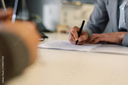 Unidentifiable individuals finalization agreement car store photo