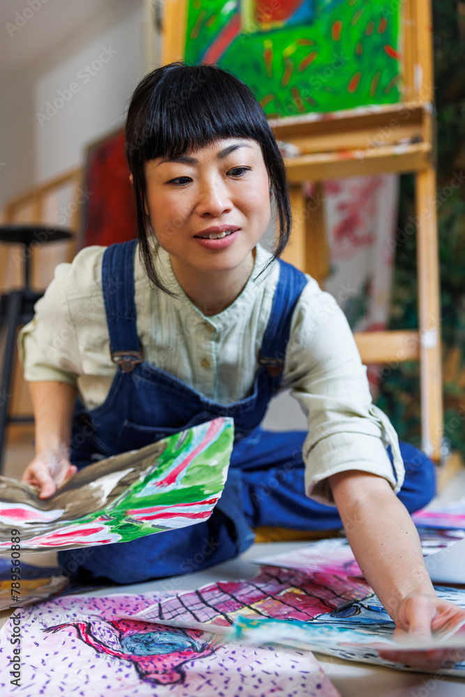 Artist choosing favorite artwork Artist choosing favorite artwork