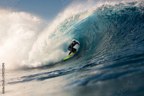 A surfer skillfully rides a giant wave near the Canary Islands photo