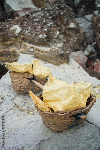 Stack of sulfur ore rocks, open mining in volcano crater photo