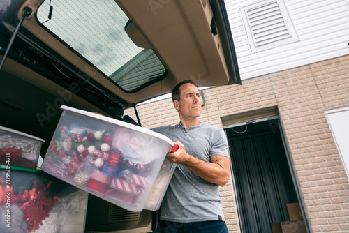 Storage: Man Storing Christmas Items In Plastic Box