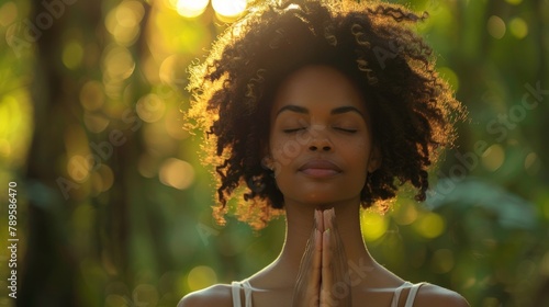 Serene Sunrise Prayer: Young African American Woman Embraces Spiritual Solitude in Forest