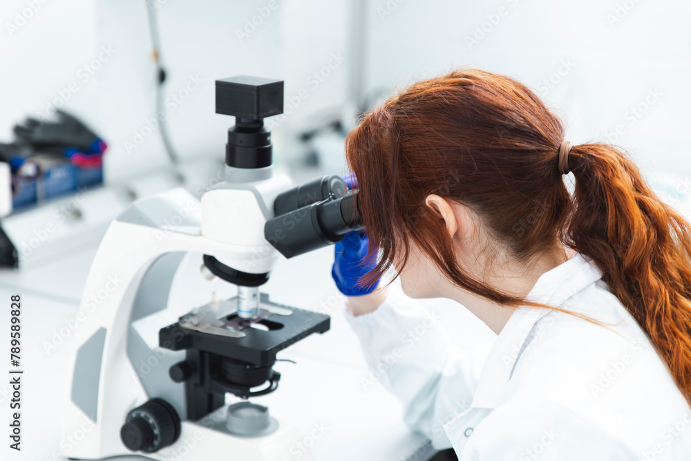 Woman Working With Microscope In Science Laboratory Woman Working With Microscope In Science Laboratory