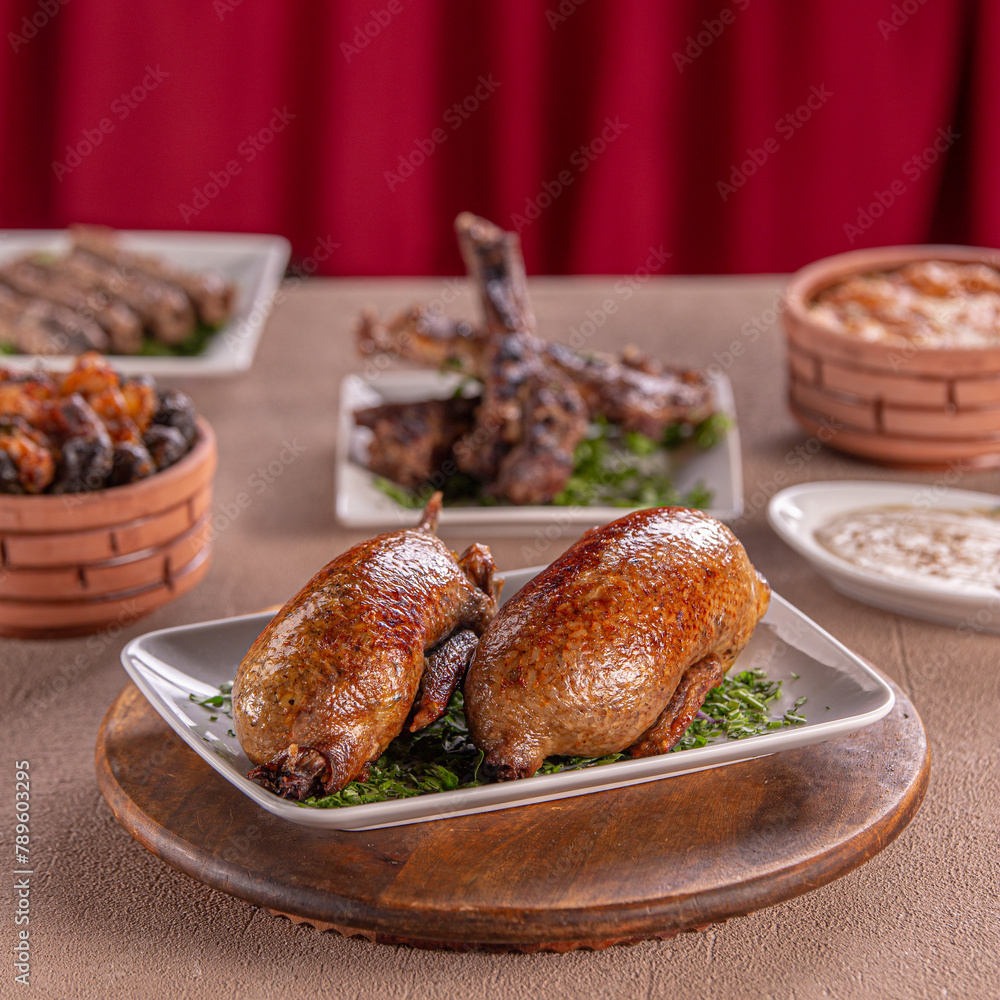 جوز حمام مصري حمام محشي مع طاجن ورق عنب ومشويات pigeon egyptian dinner on wooden tabel with mahshy twajen جوز حمام مصري حمام محشي مع طاجن ورق عنب ومشويات pigeon egyptian dinner on wooden tabel with mahshy twajen
