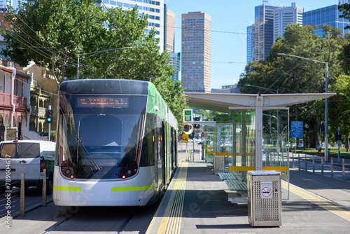 Melbourne tram with city buildings in background. photo