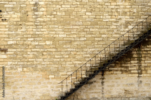 Iron Stairway Set Against Stone Wall