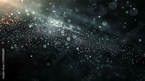 This is an abstract background of glowing particles. The particles are white and the background is black. © AiStock