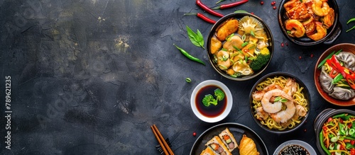 Chinese cuisine on a dark backdrop featuring dishes such as Chinese noodles, fried rice, dumplings, Peking duck, dim sum, and spring rolls. photo