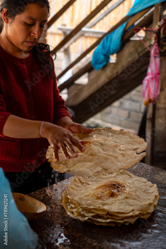 Mexican Woman with flat bread and water photo