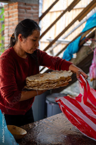 Woman packing fresh Mexican flat bread photo