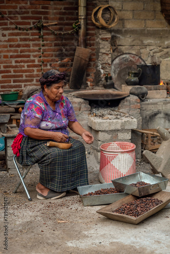 Mexican woman selecting beans for chocolate atole photo