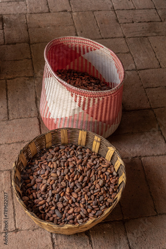 Raw chocolate beans in basket photo