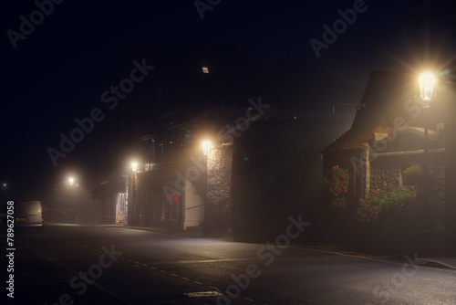 A row of shops in a village at night photo