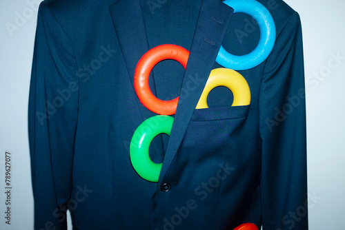 Conceptual photo of office business style suit with colourful rings photo