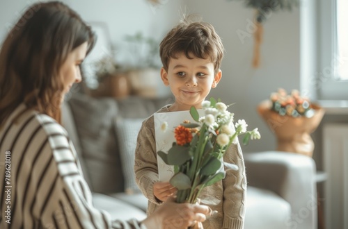 A young boy is holding a bouquet of flowers and giving them to a woman. Happy Mother's Day concept