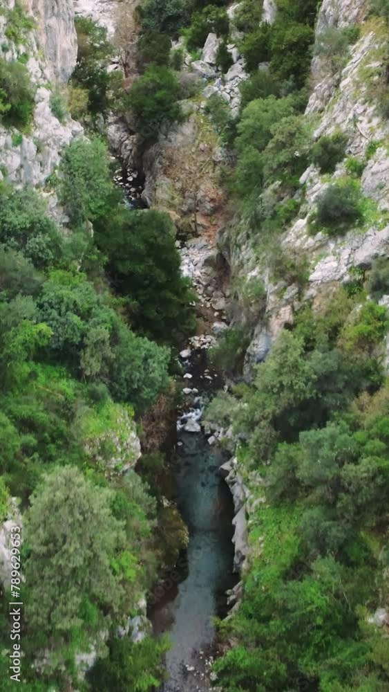 Drone flies over mountain, canyon with turquoise river. Footage captures rugged beauty of mountain, canyon landscape. Aerial view of mountain, canyon with clear water flowing Drone flies over mountain, canyon with turquoise river. Footage captures rugged beauty of mountain, canyon landscape. Aerial view of mountain, canyon with clear water flowing