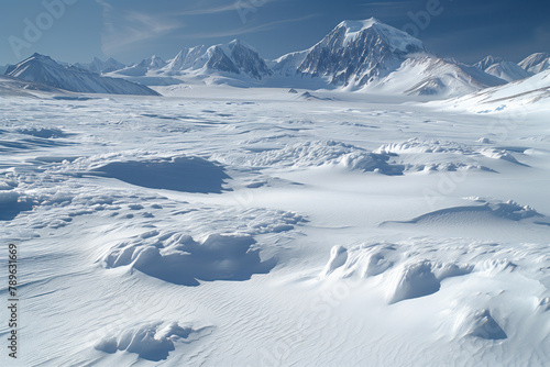 Ice sheet surface and snow-capped mountains in Antarctica
