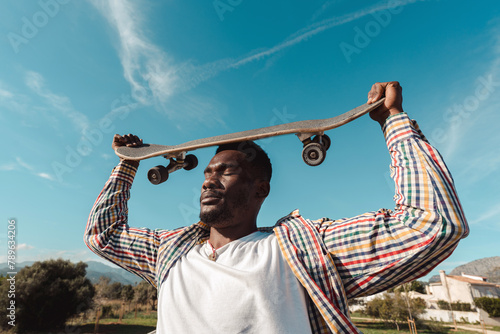 Inspired man with skateboard photo