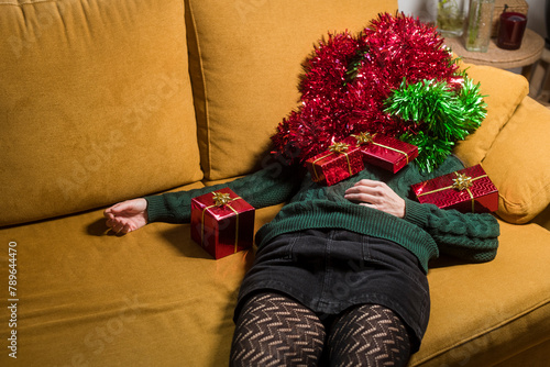 Woman covered with xmas ornaments and gifts photo