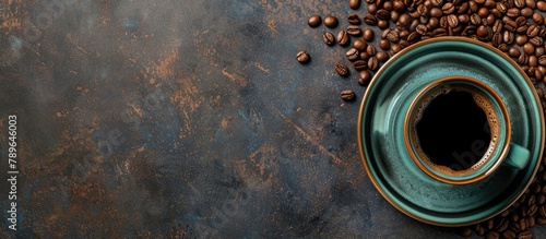 A top-down view of a table with a cup of coffee and coffee beans, with empty space for text.