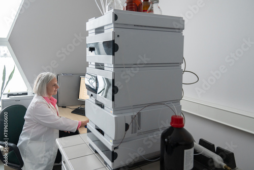 Researcher Using High Performance Liquid Chromatography Instrument photo