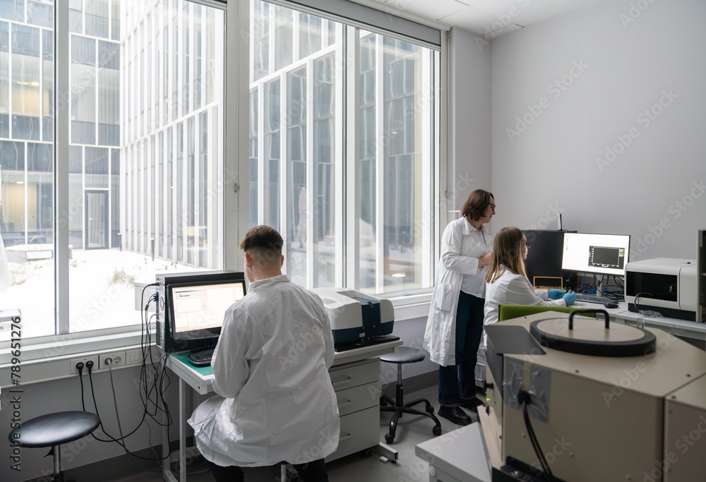 Scientists Working With A Spectrofluorometer Lab Room Scientists Working With A Spectrofluorometer Lab Room