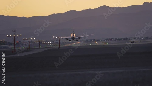 Airplane is speeding up and taking off from Harry Reid International Airport in Las Vegas at evening during sunset in beautiful place in Nevada