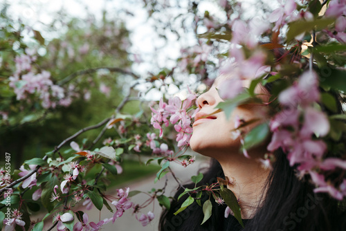 Young Serene famale in blooming garden.