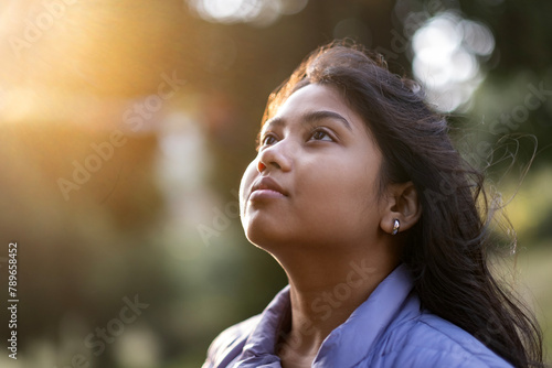 Facial expression of a young lady at afternoon light photo