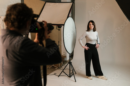 Cheerful woman posing for photo shoot in studio