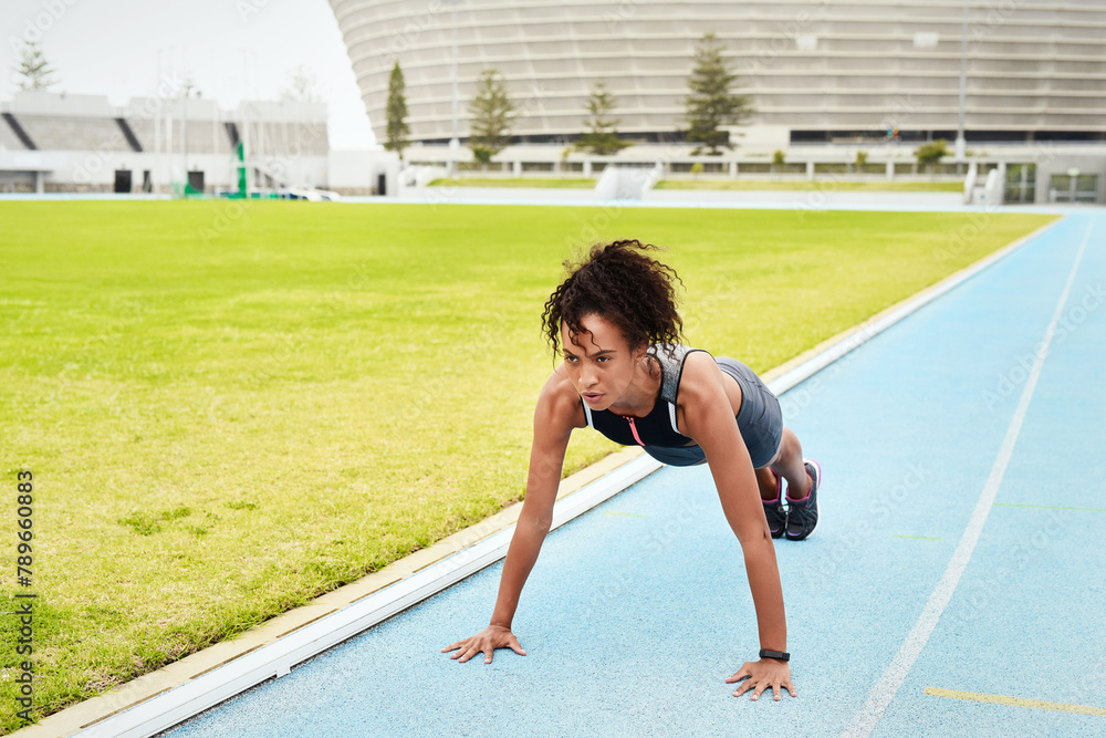 Woman, athlete and doing push up in stadium for running, training and fitness in summer. Runner, challenge and workout on track field for wellness, cardio and warm up for sports or marathon. Woman, athlete and doing push up in stadium for running, training and fitness in summer. Runner, challenge and workout on track field for wellness, cardio and warm up for sports or marathon.