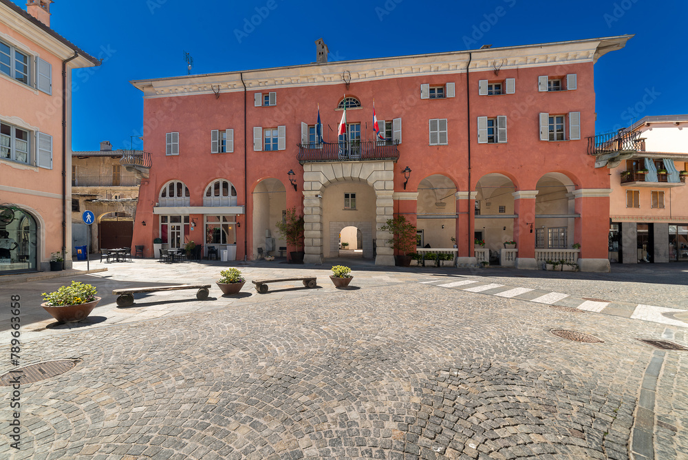 Obraz premium Chiusa di Peso, Cuneo, Italy - April 19, 2024: The town hall seen from via Roma on clear blue sky