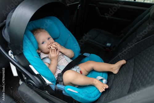 Baby girl in the blue seat for car